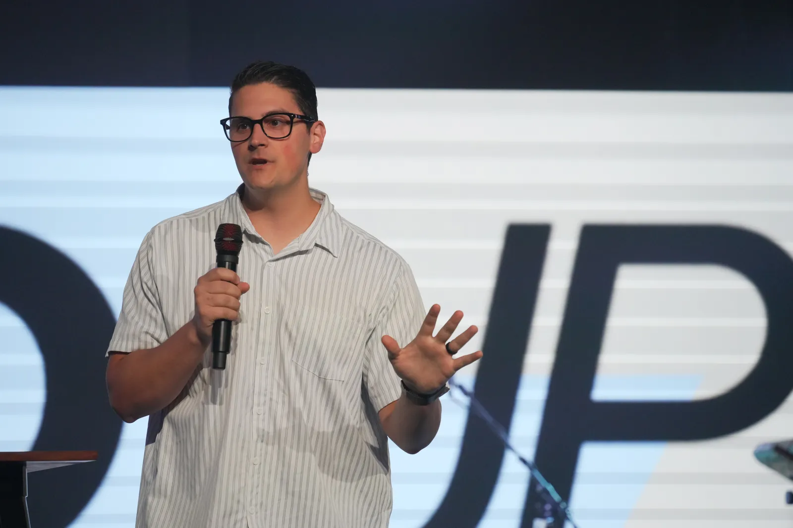Carlo Orlando teaching from the stage at Calvary Temple International